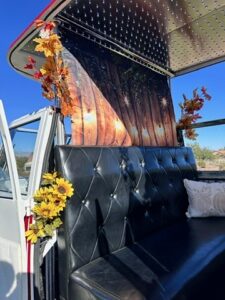 rustic-vintage-photo-booth-with-black-leather-seating-and-wood-panel-walls