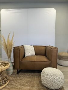 smash-booth-event-photo-area-with-modern-white-wall-and-leather-chair