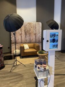 smash-booth-open-air-photo-booth-setup-with-umbrella-lights-and-rustic-backdrop