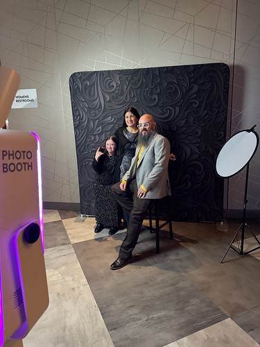 two-men-posing-in-front-of-black-floral-backdrop-at-smash-booth-photo-booth