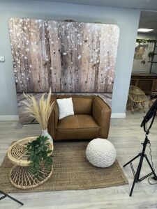 brown-leather-armchair-photo-booth-setup-with-floral-arrangements-by-smash-booth