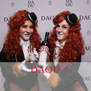 two-women-holding-drinks-posing-at-smash-booth-daou-wine-themed-photo-booth