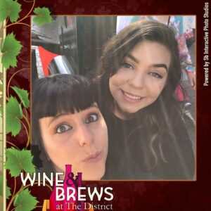 two-women-smiling-in-wine-themed-smash-booth-las-vegas-selfie