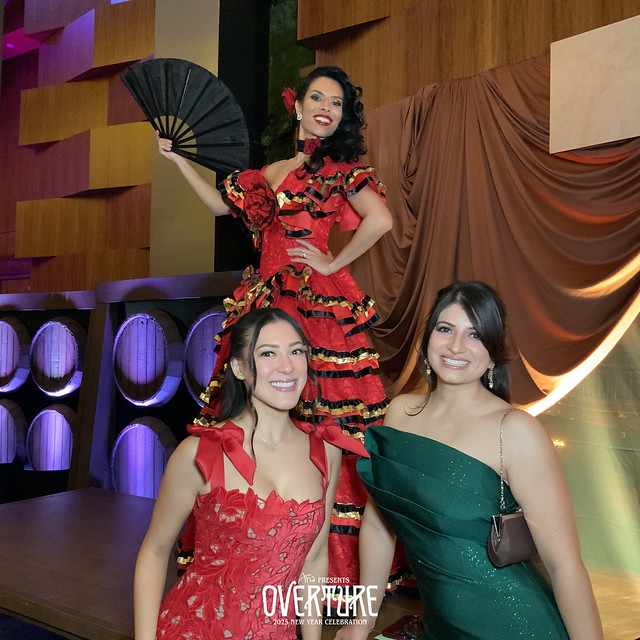three-friends-in-formal-attire-posing-on-stage-at-smash-booth-las-vegas-event