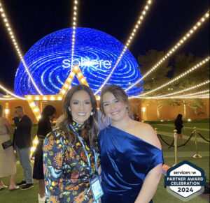 two-women-smiling-in-front-of-illuminated-ferris-wheel-at-night