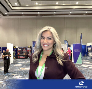 woman-with-blonde-hair-smiling-at-trade-show-booth
