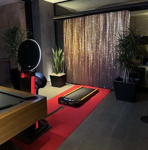 indoor-photo-booth-setup-with-red-carpet-and-curtains