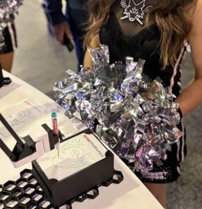 woman-with-long-hair-at-booth-showing-foil-wrapped-gift