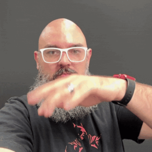 Bald-man-posing-with-hand-slow-motion-in-front-of-black-backdrop-at-photo-booth
