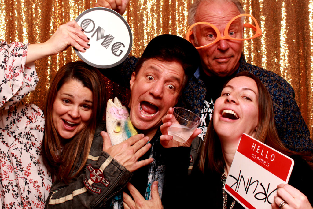 group-photo-in-photo-booth-holding-omg-sign