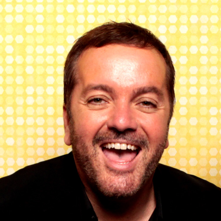 smiling-man-in-photo-booth-with-yellow-background