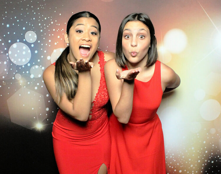 two-women-in-red-dresses-having-fun-in-gala-photo-and-video-booth-rentals